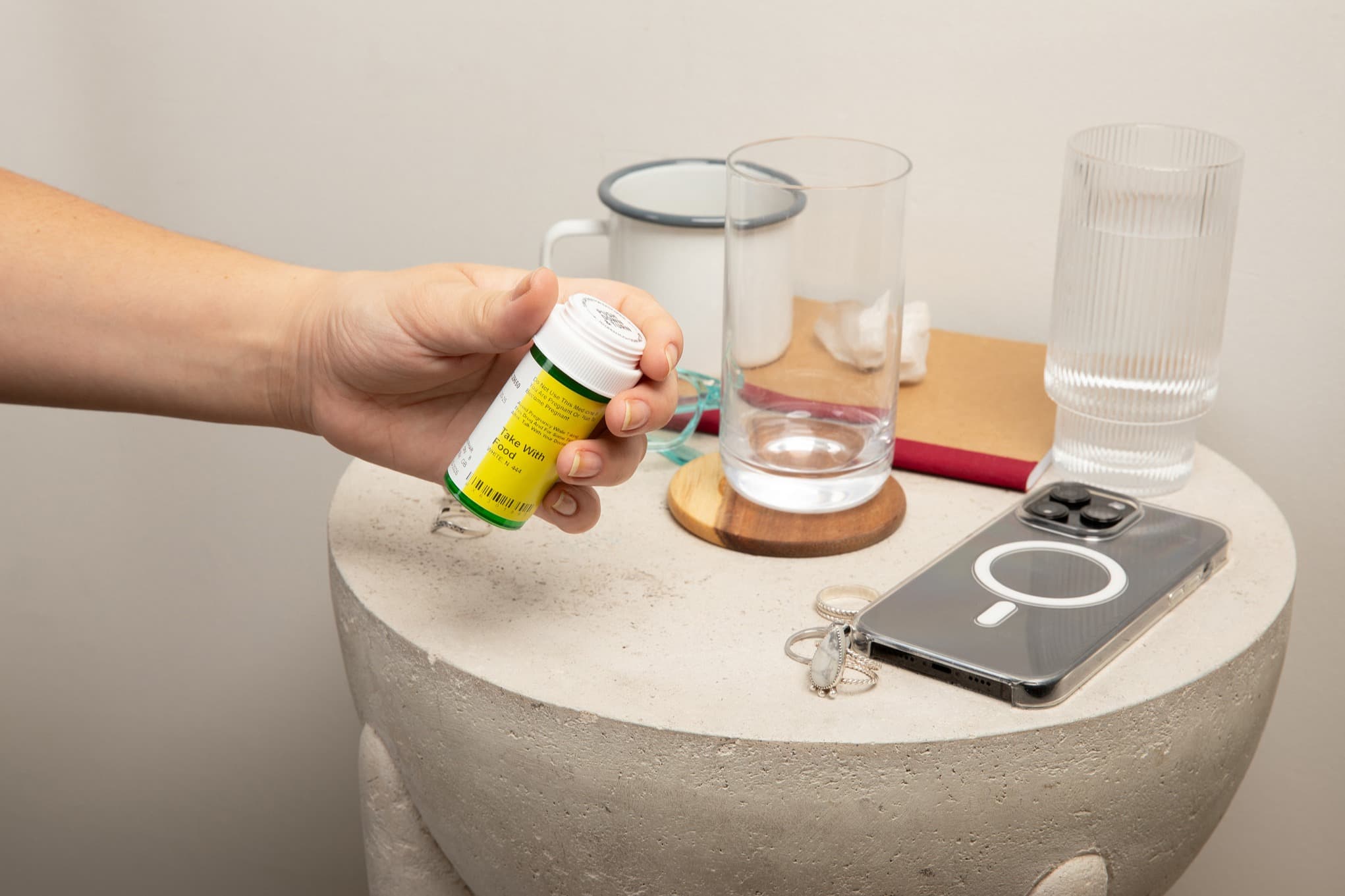 hand grabbing pills off nightstand hand grabbing pills off nightstand